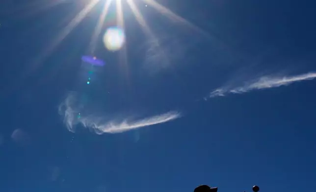 FILE - Logan Eaton, 9, plays catch in the outfield before a spring training baseball game between the Texas Rangers and the Colorado Rockies, Feb. 22, 2026, in Surprise, Ariz. (AP Photo/Charlie Riedel, File)