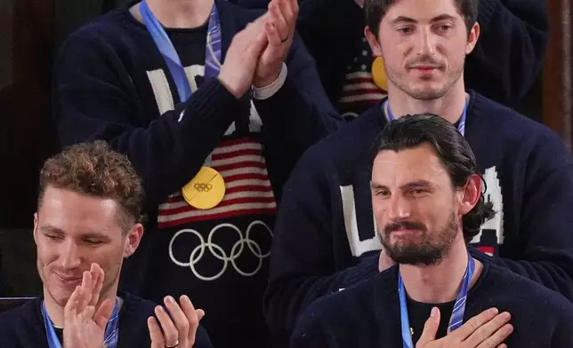 FILE - Members of the United States' Olympic gold medal hockey team react as President Donald Trump delivers the State of the Union address to a joint session of Congress in the House chamber at the U.S. Capitol in Washington, Feb. 24, 2026. (AP Photo/Matt Rourke, File)