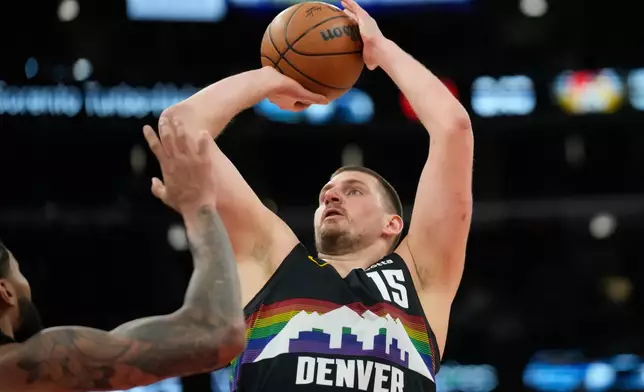 Denver Nuggets center Nikola Jokic (15), right, handles the ball as Chicago Bulls center Nick Richards (13) defends during the second half of an NBA basketball game Saturday, Feb. 7, 2026, in Chicago. (AP Photo/Erin Hooley)