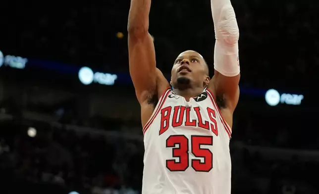 Chicago Bulls forward Isaac Okoro (35) drunks the ball during the first half of an NBA basketball game against the Denver Nuggets, Saturday, Feb. 7, 2026, in Chicago. (AP Photo/Erin Hooley)