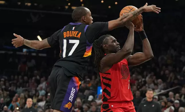 Phoenix Suns guard Jamaree Bouyea (17) pressures Portland Trail Blazers guard Jrue Holiday, right, during the first half of an NBA basketball game, Sunday, Feb. 22, 2026, in Phoenix. (AP Photo/Rick Scuteri)