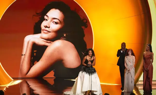 Olivia Dean accepts the award for best new artis during the 68th annual Grammy Awards on Sunday, Feb. 1, 2026, in Los Angeles. Chappell Roan looks on from right. (AP Photo/Chris Pizzello)