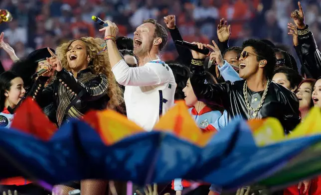 FILE - Beyoncé, from left, Coldplay singer Chris Martin and Bruno Mars perform during halftime of the NFL Super Bowl 50 football game in Santa Clara, Calif., on Feb. 7, 2016. (AP Photo/Julio Cortez, File)