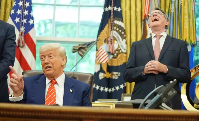 FILE - President Donald Trump, left, gets a reaction from Britian's ambassador to the United States Peter Mandelson, right, as they take questions from members of the media after announcing a trade deal between U.S. and U.K. in the Oval Office of the White House, Thursday, May 8, 2025, in Washington. (AP Photo/Evan Vucci, file)