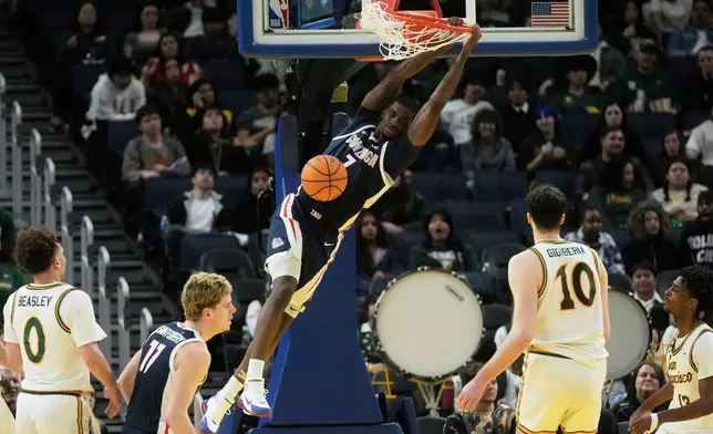 Gonzaga guard Tyon Grant-Foster, top, dunks against San Francisco during the second half of an NCAA college basketball game in San Francisco, Wednesday, Feb. 18, 2026. (AP Photo/Jeff Chiu)