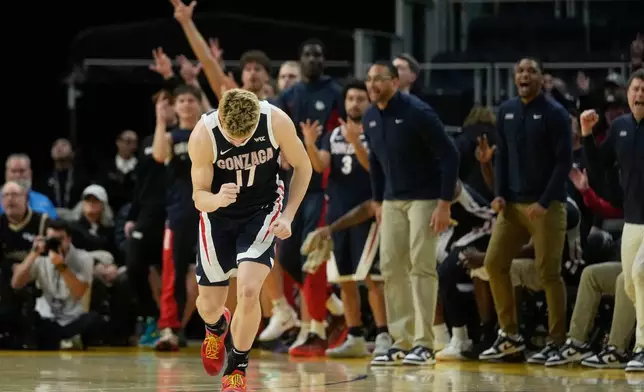 Gonzaga guard Mario Saint-Supery (17) reacts after making a 3-point basket against San Francisco during the second half of an NCAA college basketball game in San Francisco, Wednesday, Feb. 18, 2026. (AP Photo/Jeff Chiu)
