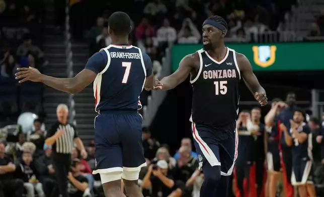 Gonzaga guard Tyon Grant-Foster (7) celebrates with forward Graham Ike (15) during the second half of an NCAA college basketball game against San Francisco in San Francisco, Wednesday, Feb. 18, 2026. (AP Photo/Jeff Chiu)