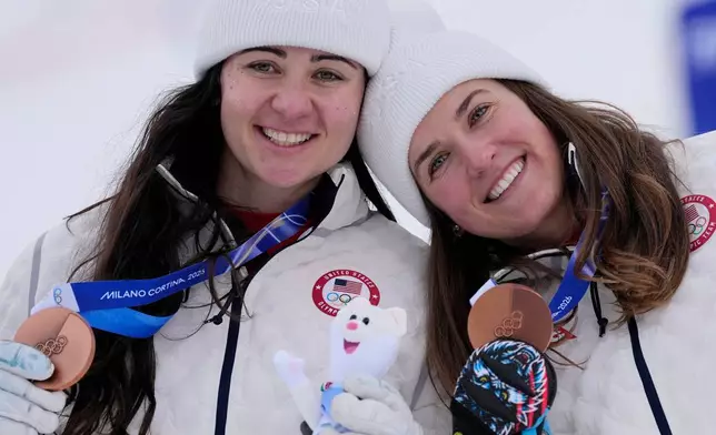 United States' Jacqueline Wiles, left, and teammate United States' Paula Moltzan show their bronze medals in an alpine ski, women's team combined race, at the 2026 Winter Olympics, in Cortina d'Ampezzo, Italy, Tuesday, Feb. 10, 2026. (AP Photo/Andy Wong)