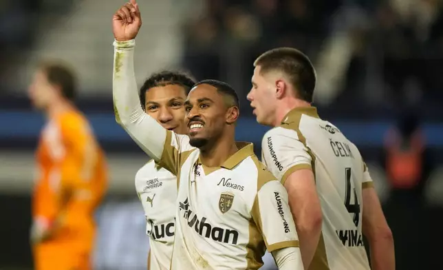 Lens's Wesley Said, center, celebrates with his teammates scoring a side goal during the French League One soccer match between Paris FC and Lens in Paris, Saturday, Feb. 14, 2026. (AP Photo/Michel Euler)