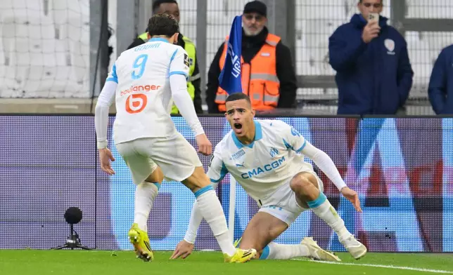 Marseille's Mason Greenwood, right, celebrates scoring his side's opening goal during the French League One soccer match between Marseille and Strasbourg in Marseille, France, Saturday, Feb. 14, 2026. (AP Photo/Philippe Magoni)