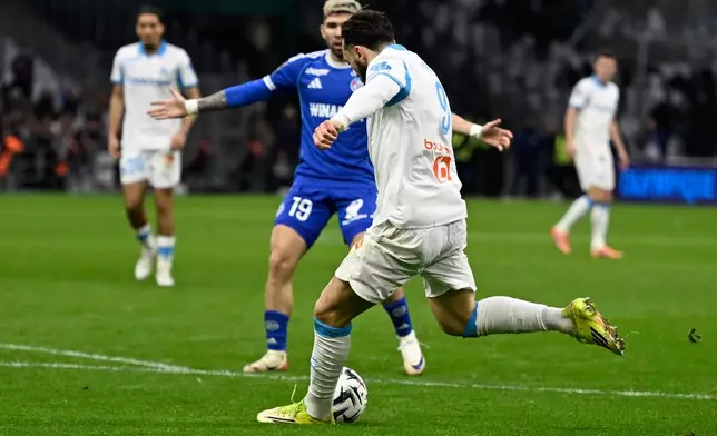 Marseille's Amine Gouiri scores his side's 2nd goal during the French League One soccer match between Marseille and Strasbourg in Marseille, France, Saturday, Feb. 14, 2026. (AP Photo/Philippe Magoni)