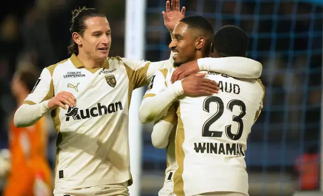 Lens's Wesley Said, center, celebrates with his teammates scoring a side goal during the French League One soccer match between Paris FC and Lens in Paris, Saturday, Feb. 14, 2026. (AP Photo/Michel Euler)