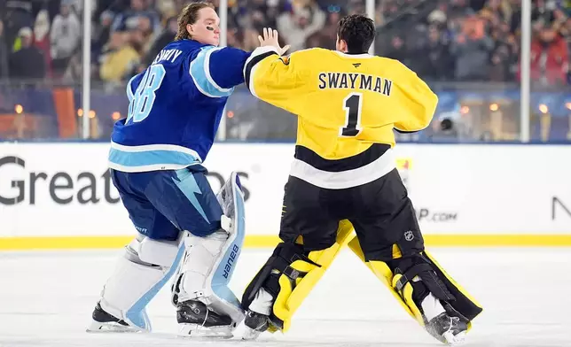 Tampa Bay Lightning goaltender Andrei Vasilevskiy (88) and Boston Bruins goaltender Jeremy Swayman (1) fight during the second period of a Stadium Series NHL hockey game Sunday, Feb. 1, 2026, in Tampa, Fla. (AP Photo/Chris O'Meara)