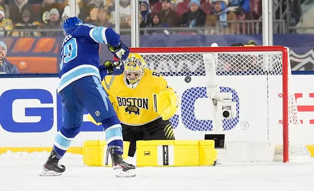 Tampa Bay Lightning center Jake Guentzel (59) scores past Boston Bruins goaltender Jeremy Swayman (1) during a shootout in a Stadium Series NHL hockey game Sunday, Feb. 1, 2026, in Tampa, Fla. (AP Photo/Chris O'Meara)
