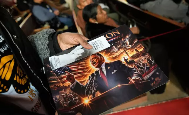 A person holds a calendar with a photo of Reverend Jesse Jackson during the public visitation at Rainbow/PUSH Coalition in Chicago, Friday, Feb. 27, 2026. (AP Photo/Nam Y. Huh)