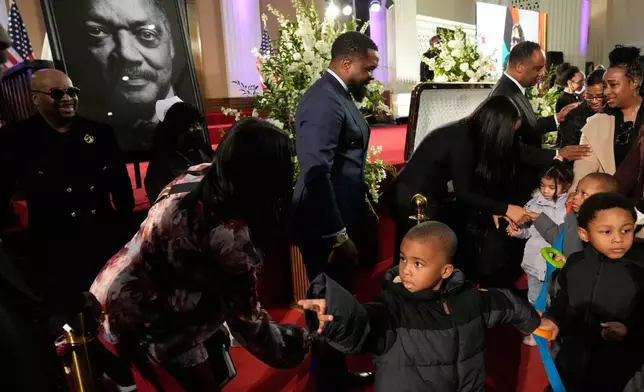 Children from Angels of Joy Academy are greeted during public visitation for Reverend Jesse Jackson at at Rainbow/PUSH Coalition in Chicago, Friday, Feb. 27, 2026. (AP Photo/Nam Y. Huh)