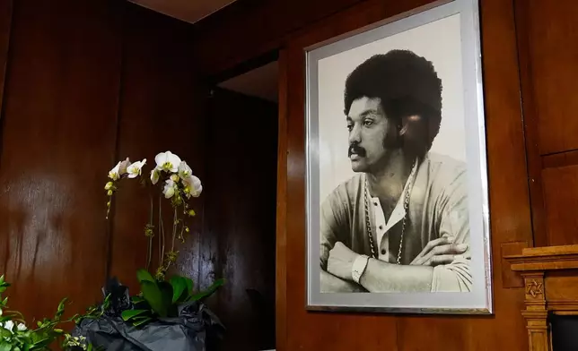 White orchids sit on a table next to a framed photo of Rev. Jesse Jackson during a public visitation for him at Rainbow PUSH Coalition headquarters Friday, Feb. 27, 2026, in Chicago. (AP Photo/Erin Hooley)