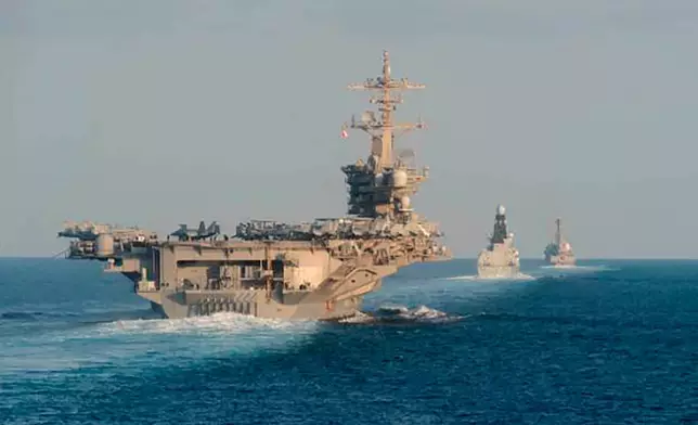 FILE - In this Nov. 19, 2019, photo made available by U.S. Navy, the aircraft carrier USS Abraham Lincoln, left, the air-defense destroyer HMS Defender and the guided-missile destroyer USS Farragut transit the Strait of Hormuz with the guided-missile cruiser USS Leyte Gulf. (Mass Communication Specialist 3rd Class Zachary Pearson/U.S. Navy via AP, File)
