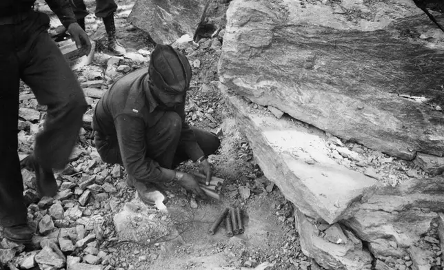 FILE - In this 1942 photo provided by the U.S. Army Corps of Engineers Office of History, a Black soldier places dynamite during construction of the Alaska Highway in the Northern Sector of Alaska. (U.S. Army Corps of Engineers Office of History via AP, File)