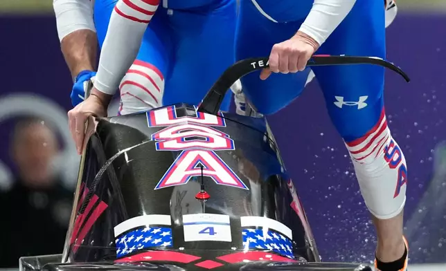 United States' Frankie del Duca, right, and Joshua Williamson start for a two man bobsled run at the 2026 Winter Olympics, in Cortina d'Ampezzo, Italy, Monday, Feb. 16, 2026. (AP Photo/Alessandra Tarantino)