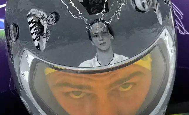 Ukraine's Vladyslav Heraskevych starts a men's skeleton training session at the 2026 Winter Olympics, in Cortina d'Ampezzo, Italy, Monday, Feb. 9, 2026. (AP Photo/Alessandra Tarantino)