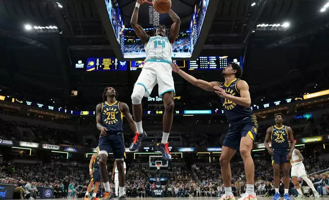 Charlotte Hornets forward Moussa Diabate (14) dunks in front of Indiana Pacers guard Quenton Jackson (29) during the second half of an NBA basketball game in Indianapolis, Thursday, Feb. 26, 2026. (AP Photo/AJ Mast)