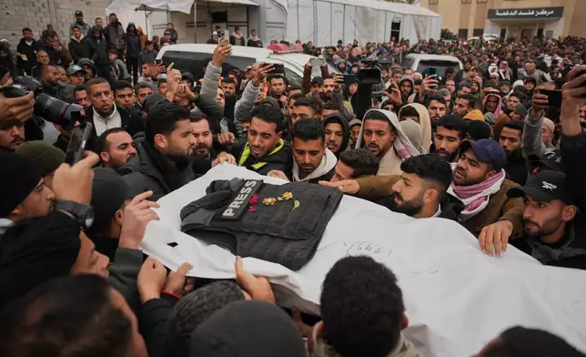 FILE - Mourners carry the body of Abd Shaat, one of the three Palestinian journalists who were killed in an Israeli strike on an Egyptian committee's vehicle, during his funeral in Khan Younis, southern Gaza Strip, Jan. 22, 2026. (AP Photo/Abdel Kareem Hana, File)