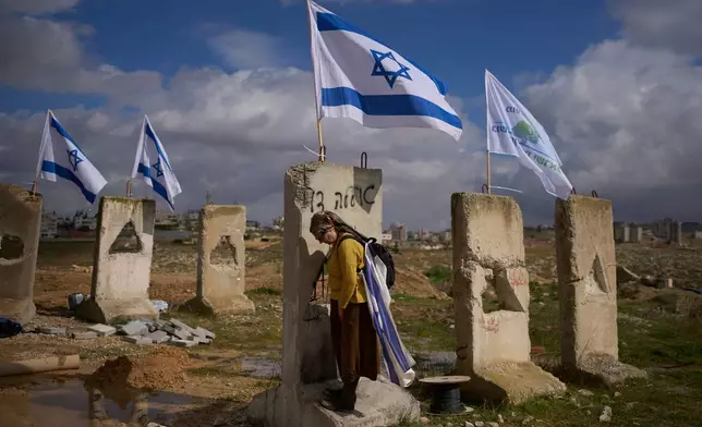 FILE - A woman attends the inauguration ceremony of a newly-legalized Jewish settlement, Yatziv, adjacent to the Palestinian town of Beit Sahour, in the West Bank, Jan. 19, 2026. (AP Photo/Ohad Zwigenberg, File)