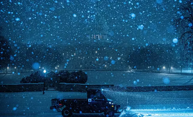 FILE - A plow clears snow in front of the U.S. Capitol in Washington, Jan. 25, 2026. (AP Photo/Julia Demaree Nikhinson, File)