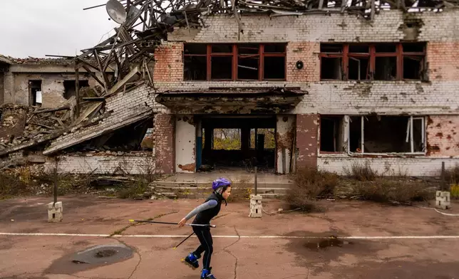 FILE - A young biathlete trains outside the destroyed ski base in Chernihiv, Ukraine, Oct. 30, 2025. (AP Photo/Julia Demaree Nikhinson, File)