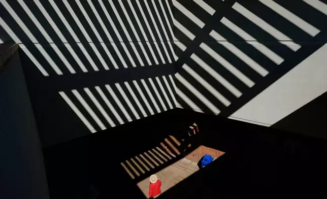 A man walks through the concourse before a spring training baseball game between the San Diego Padres and the Seattle Mariners, Friday, Feb. 20, 2026, in Peoria, Ariz. (AP Photo/Charlie Riedel)