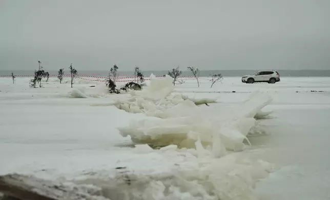 A car drives on the frozen Soela Strait in the Baltic Sea near Hiiumaa, Estonia, Tuesday, Feb. 10, 2026. (AP Photo/Kostya Manekov)