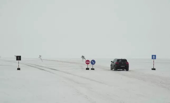 A car drives on the frozen Soela Strait in the Baltic Sea near Hiiumaa, Estonia, Tuesday, Feb. 10, 2026. (AP Photo/Kostya Manekov)