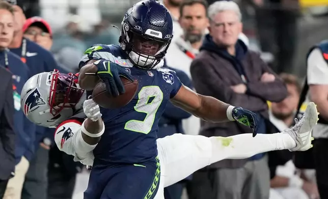 Seattle Seahawks running back Kenneth Walker III (9) runs against New England Patriots cornerback Marcus Jones during the second half of the NFL Super Bowl 60 football game, Sunday, Feb. 8, 2026, in Santa Clara, Calif. (AP Photo/Doug Benc)