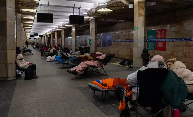 People take shelter in a metro station, being used as a bomb shelter, during a Russian drones attack in Kyiv, Ukraine, Tuesday, Feb. 3, 2026. (AP Photo/Alex Babenko)