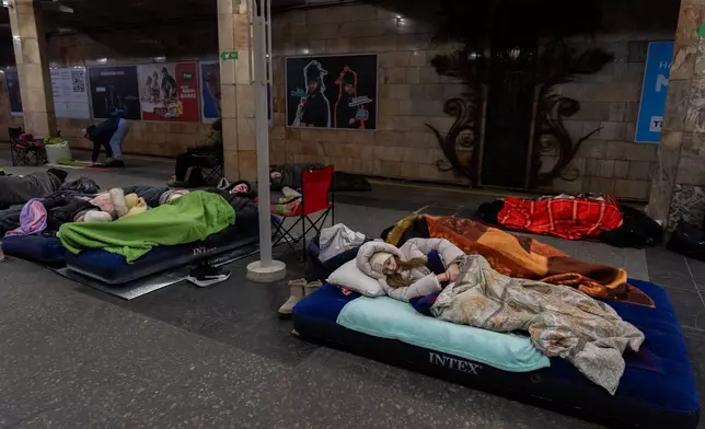 People take shelter in a metro station, being used as a bomb shelter, during a Russian drones attack in Kyiv, Ukraine, Tuesday, Feb. 3, 2026. (AP Photo/Alex Babenko)