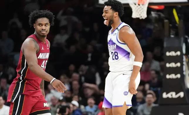 Utah Jazz forward Brice Sensabaugh (28) gestures to Miami Heat guard Davion Mitchell (45) after scoring a three-point basket during the second half of an NBA basketball game Monday, Feb. 9, 2026, in Miami. (AP Photo/Marta Lavandier)