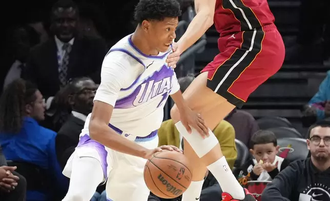 Utah Jazz guard Ace Bailey (19) dribbles the ball as Miami Heat forward Simone Fontecchio (0) defends during the first half of an NBA basketball game Monday, Feb. 9, 2026, in Miami. (AP Photo/Marta Lavandier)