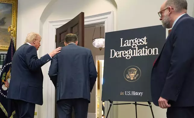 President Donald Trump departs with Environmental Protection Agency director Lee Zeldin and Office of Management and Budget director Russell Vought, right after announcing the EPA will no longer regulate greenhouse gases, in the Roosevelt Room of the White House, Thursday, Feb. 12, 2026, in Washington. (AP Photo/Evan Vucci)
