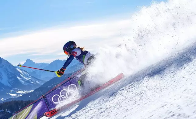 United States' Mikaela Shiffrin speeds down the course during an alpine ski, women's slalom race, at the 2026 Winter Olympics, in Cortina d'Ampezzo, Italy, Wednesday, Feb. 18, 2026. (AP Photo/Robert F. Bukaty)