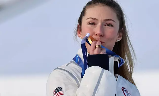 United States' Mikaela Shiffrin kisses the gold medal of the alpine ski, women's slalom race, at the 2026 Winter Olympics, in Cortina d'Ampezzo, Italy, Wednesday, Feb. 18, 2026. (AP Photo/Marco Trovati)