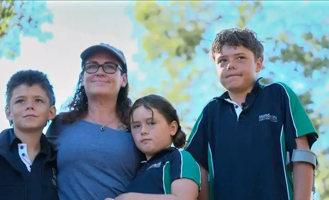 This image taken from video shows Austin Appelbee, right, posing with his family in Gidgegannup, Australia, Tuesday Feb. 3, 2026. (ABC via AP)