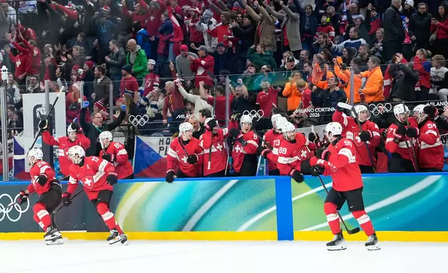 Switzerland players celebrate their victory after a preliminary round match of men's ice hockey between Switzerland and Czechia at the 2026 Winter Olympics, in Milan, Italy, Sunday, Feb. 15, 2026. (AP Photo/Petr David Josek)