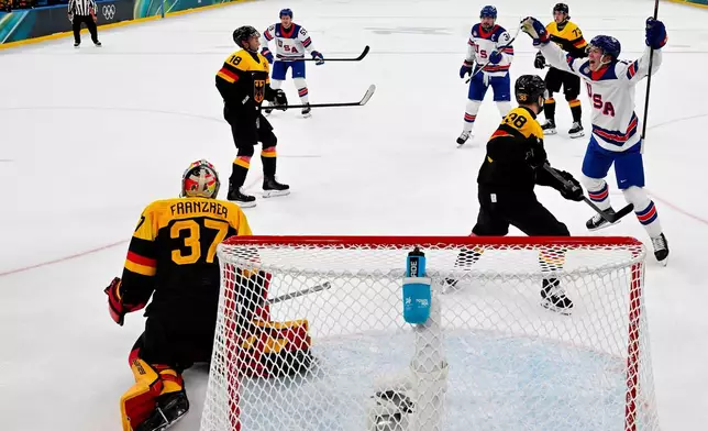 The United States Matt Boldy (12) celebrates after the team's second goal by Auston Matthews (34) during a preliminary round game of men's ice hockey between the United States and Germany at the 2026 Winter Olympics, in Milan, Italy, Sunday, Feb. 15, 2026. (Alexander Nemenov/Pool Photo via AP)