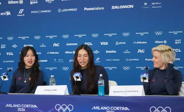 United States' Chloe Kim, center, speaks as Bea Kim, left, and Madeline Schaffrick look on during a press conference at the 2026 Winter Olympics, in Livigno, Italy, Monday, Feb. 9, 2026. (AP Photo/Lindsey Wasson)