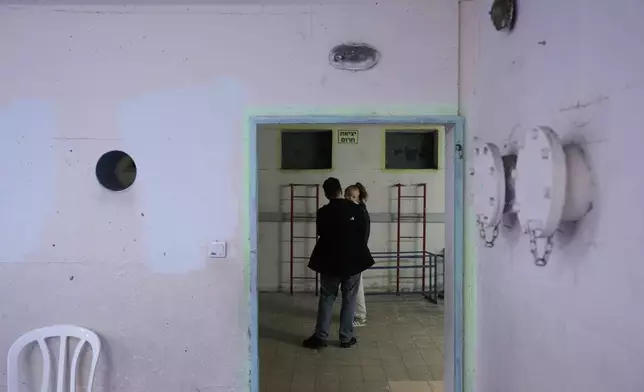Civilians staying in a shelter after alarms announced that Israel had launched an attack on Iran, in Ramat Gan, Israel, Saturday, Feb. 28, 2026. (AP Photo/Oded Balilty)
