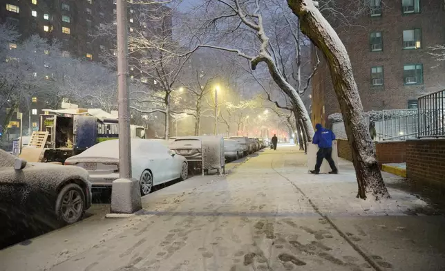 A man works in a snowstorm, Sunday, Feb. 22, 2026, in New York. (AP Photo/Pamela Hassell)