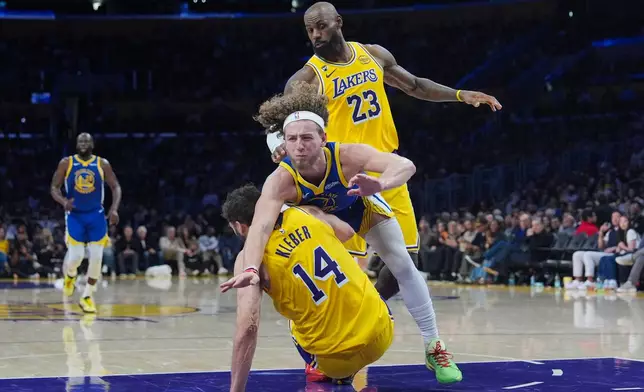 Los Angeles Lakers forward LeBron James (23) watches as forward Maxi Kleber (14) is fouled by Golden State Warriors guard Brandin Podziemski (2) during the first half of an NBA basketball game Saturday, Feb. 7, 2026, in Los Angeles. (AP Photo/Jae C. Hong)