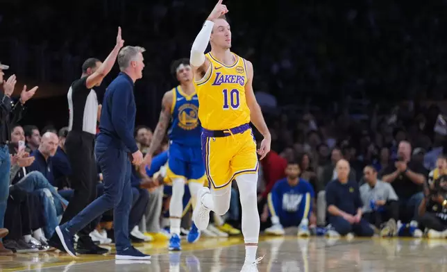 Los Angeles Lakers guard Luke Kennard (10) reacts to a play during the first half of an NBA basketball game against the Golden State Warriors Saturday, Feb. 7, 2026, in Los Angeles. (AP Photo/Jae C. Hong)