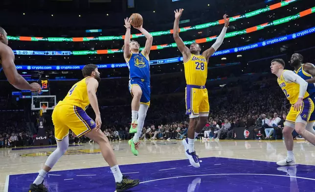 Golden State Warriors guard Brandin Podziemski (2) goes up for basket under defense by Los Angeles Lakers forward Rui Hachimura (28) during the first half of an NBA basketball game Saturday, Feb. 7, 2026, in Los Angeles. (AP Photo/Jae C. Hong)